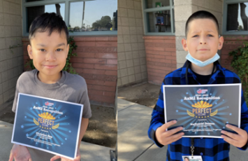  two students holding perfect score certificates